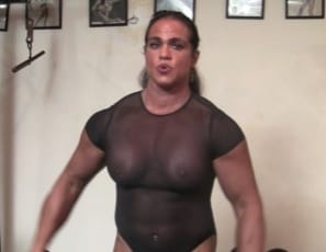 In the gym, Female bodybuilder Dana is doing biceps curls and posing in a sheer bodysuit